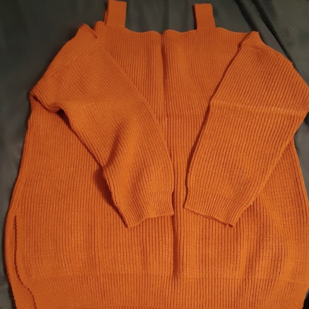 Open shoulder knit sweater. New. Rust colored.